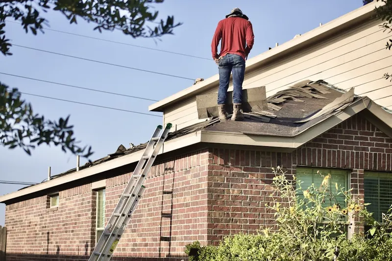 Professional roofer working on a residential roof in Carriage Hills